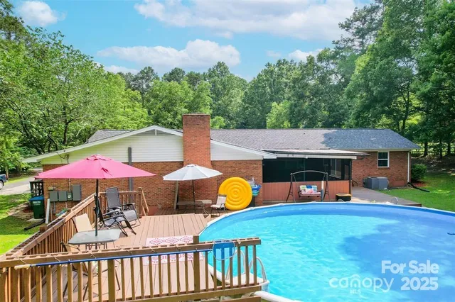 an outdoor space with pool and furniture