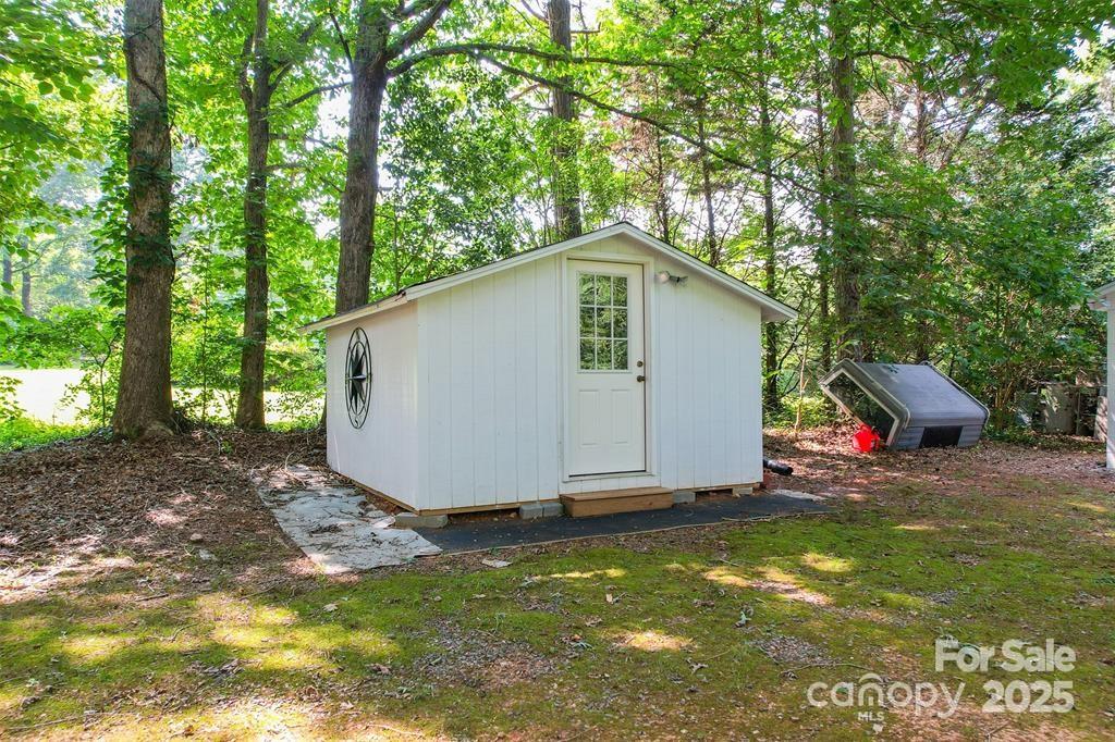4805 Nesbit Road Monroe, NC 28112 - Photo 38 of 40 a view of a backyard with a small cabin