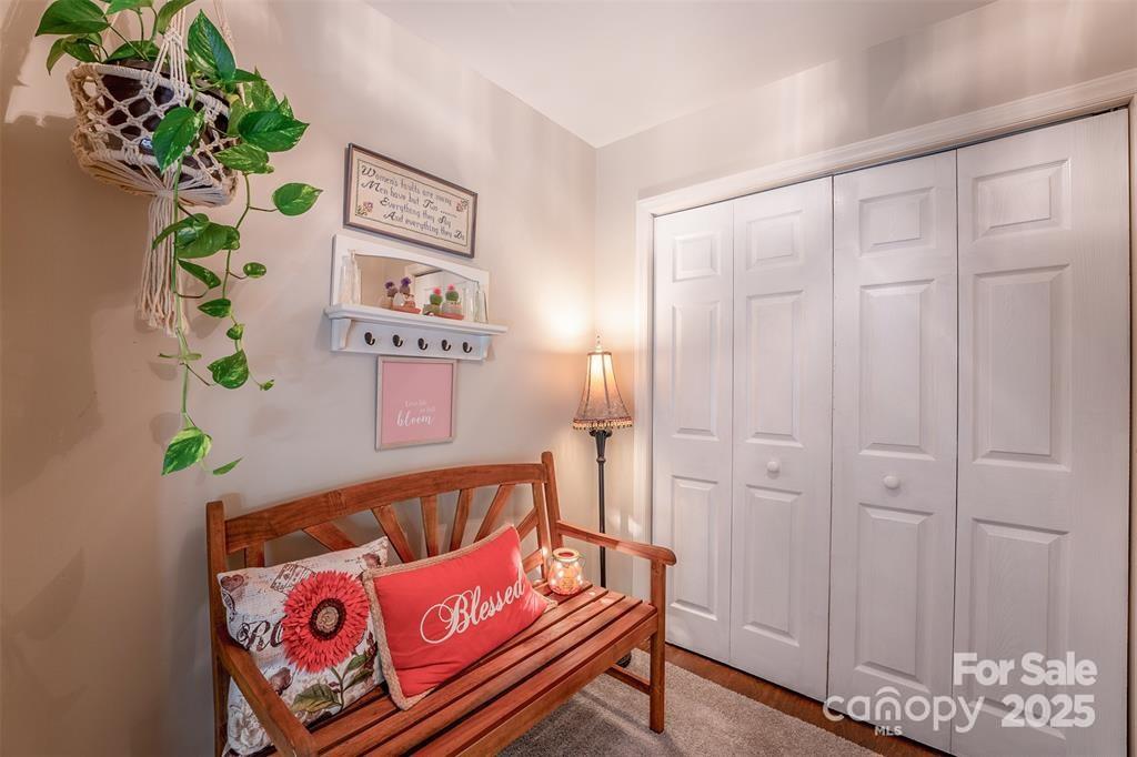 4805 Nesbit Road Monroe, NC 28112 - Photo 6 of 40 a bench sitting in a bedroom with a book shelf