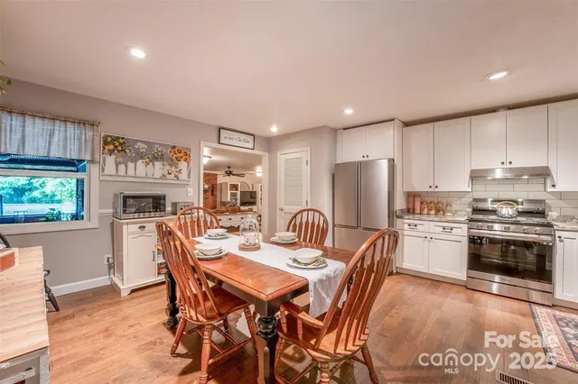 a view of a dining room with furniture window and wooden floor