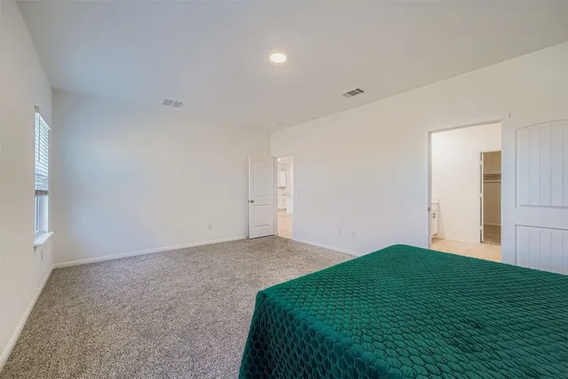 a room with a dresser and a window