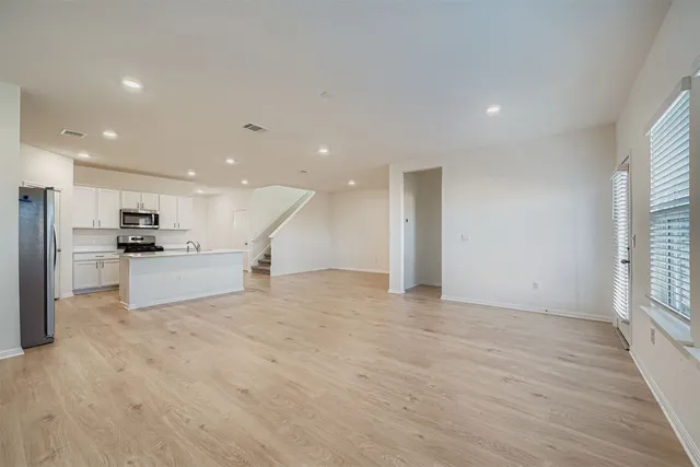 a view of kitchen with refrigerator and window