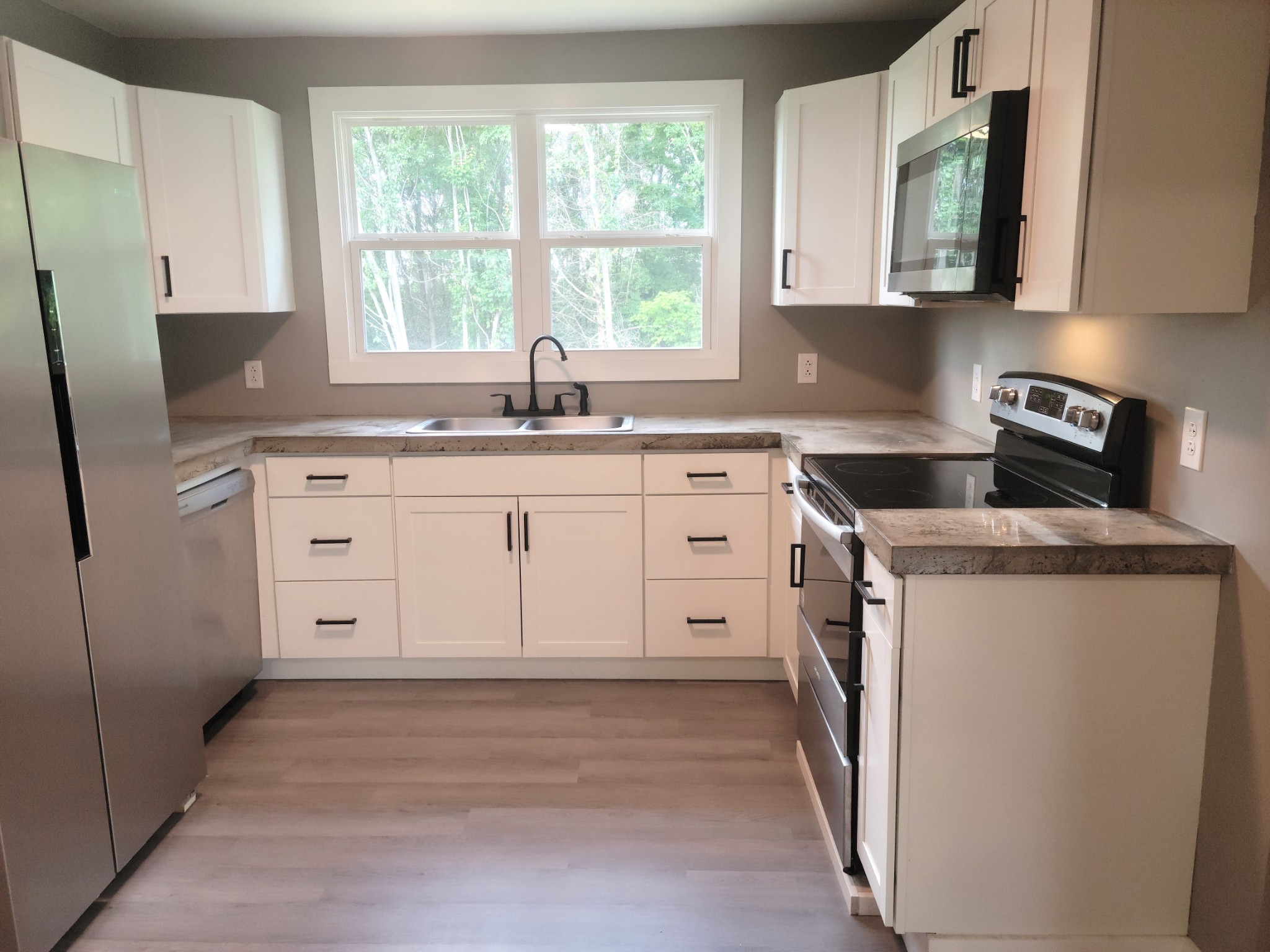 a kitchen with white cabinets and white appliances