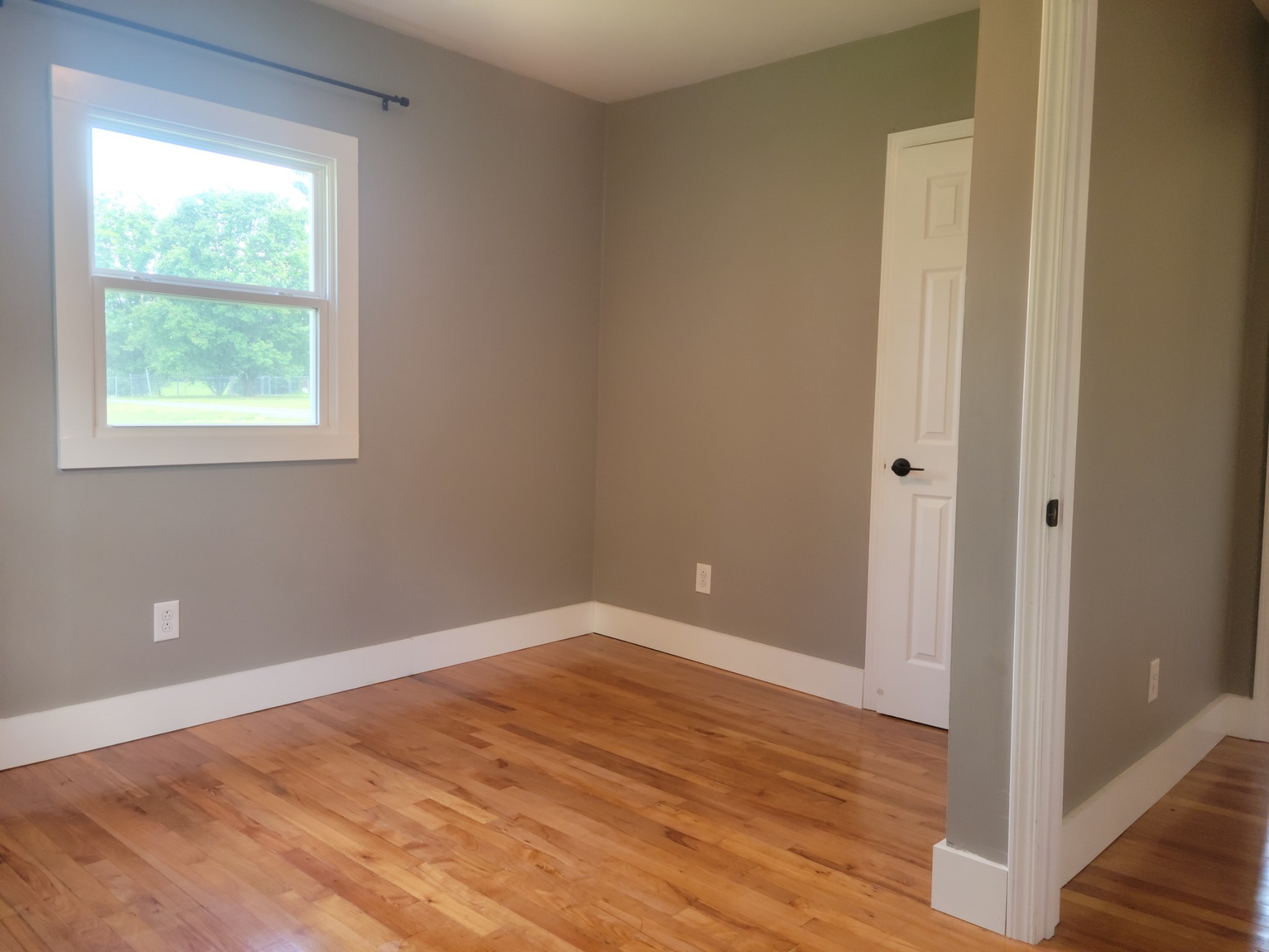 4666 Talley Road Springfield, TN 37172 - Photo 8 of 12 a view of an empty room with wooden floor and a window