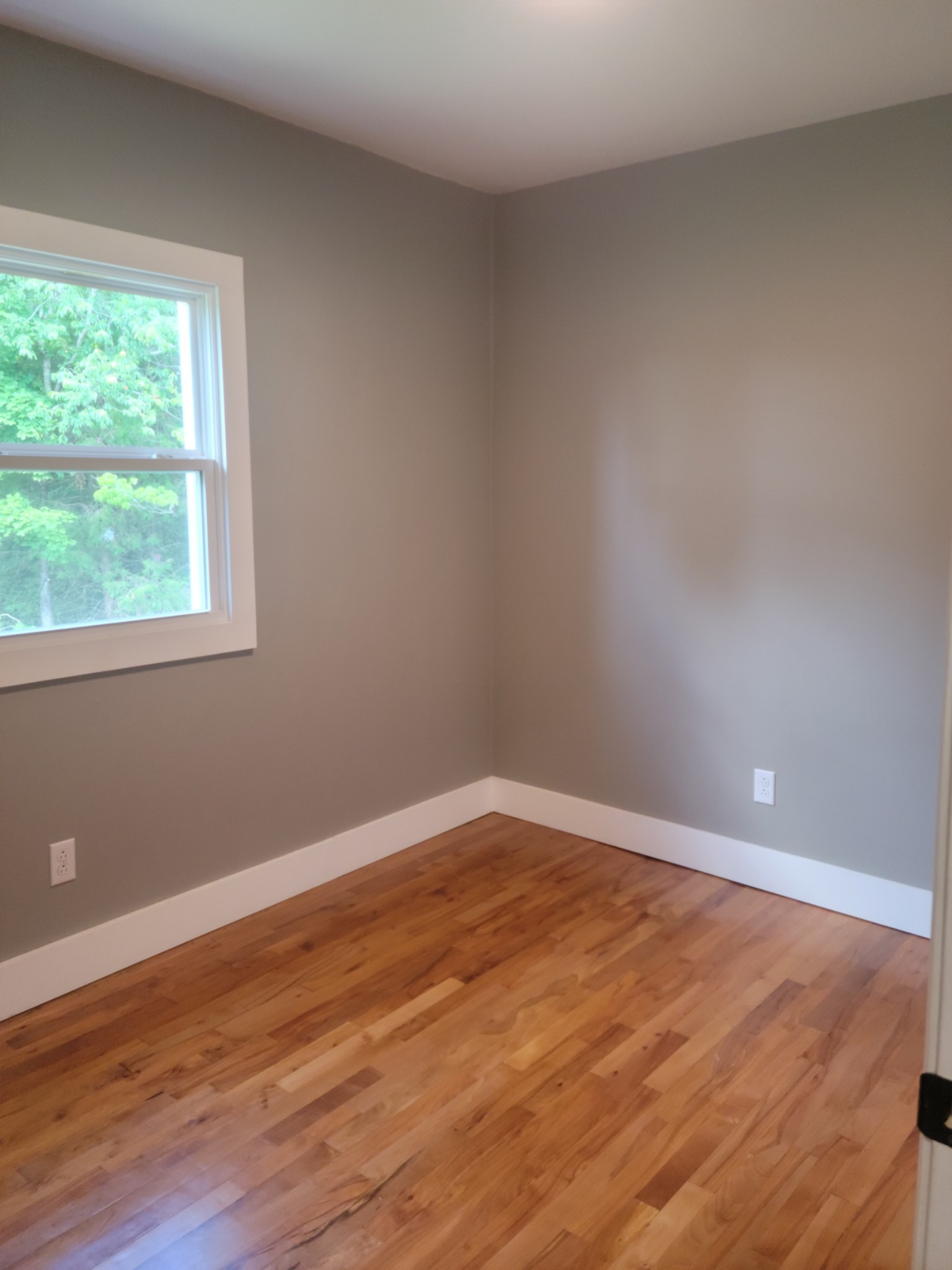 4666 Talley Road Springfield, TN 37172 - Photo 9 of 12 a view of an empty room with wooden floor and a window