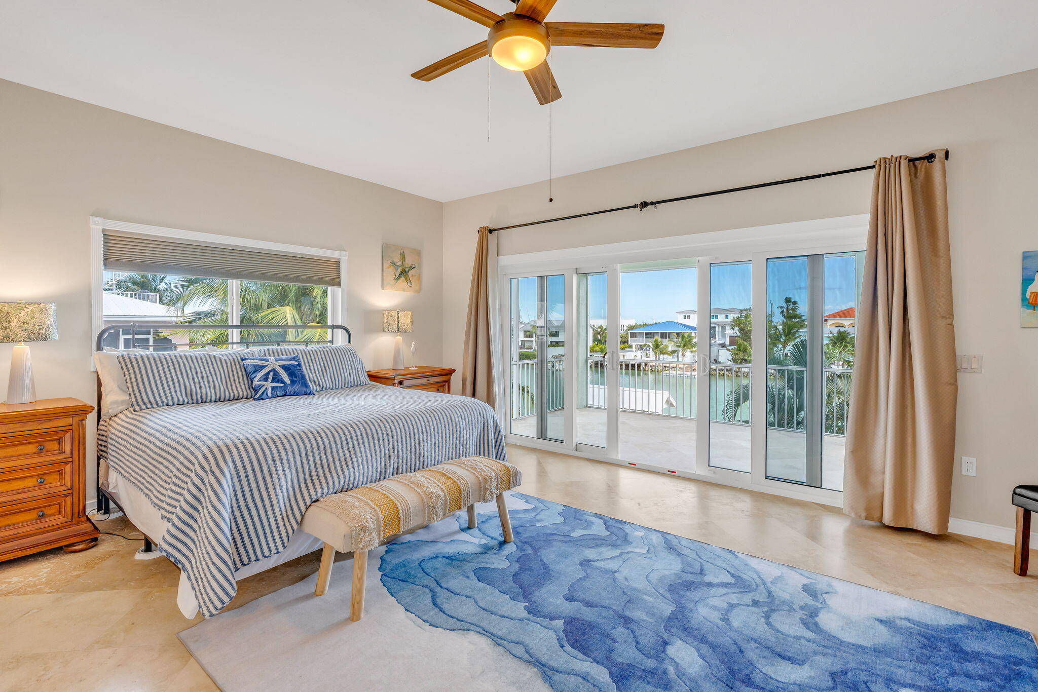 151 Ave G Marathon, FL 33050 - Photo 7 of 56 a bedroom with a large bed and a chandelier