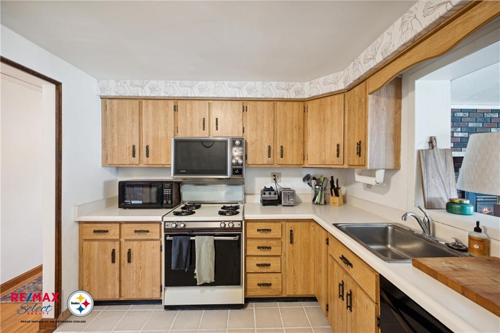 132 Shafer Road Coraopolis, PA 15108 - Photo 11 of 39 a kitchen with a stove a sink and a refrigerator