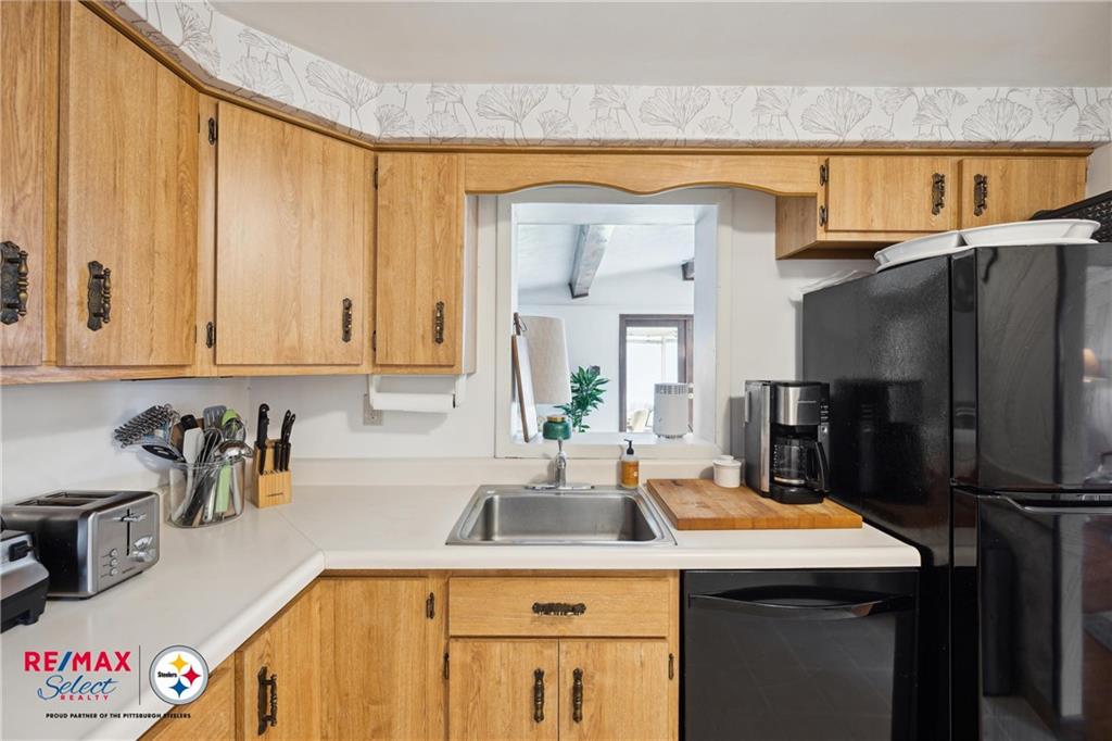 132 Shafer Road Coraopolis, PA 15108 - Photo 12 of 39 a kitchen with a sink a refrigerator and cabinets