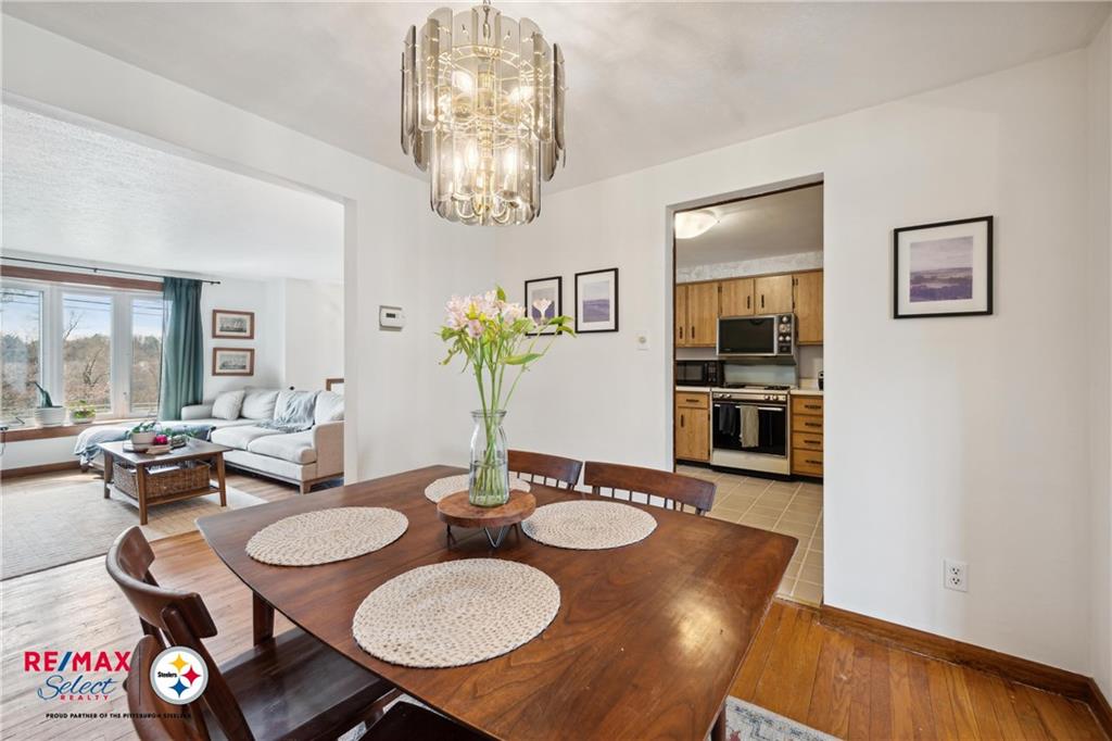 132 Shafer Road Coraopolis, PA 15108 - Photo 16 of 39 a view of a dining room with furniture a chandelier and wooden floor