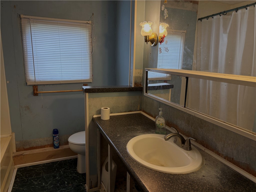 5434 North Waynesville Road, Unit 15 Oregonia, OH 45054 - Photo 5 of 19 This bathroom features a functional vanity and window, offering practical everyday convenience.