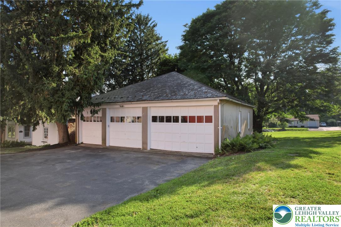 4682 Steuben Road Bethlehem, PA 18020 - Photo 50 of 79 A well-maintained three-car garage and asphalt driveway are framed by mature trees and verdant lawns.