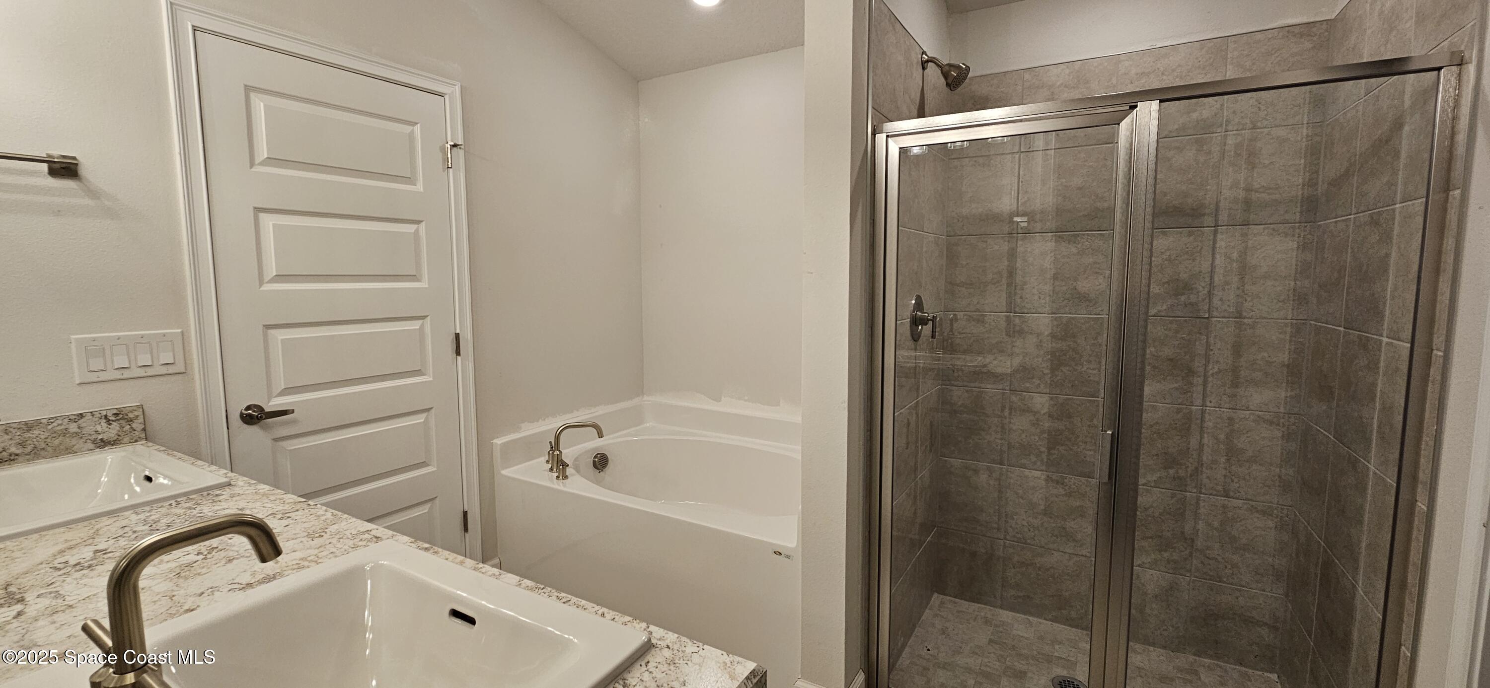 1211 Tupelo Circle Cocoa, FL 32926 - Photo 11 of 15 a bathroom with a tub and a sink