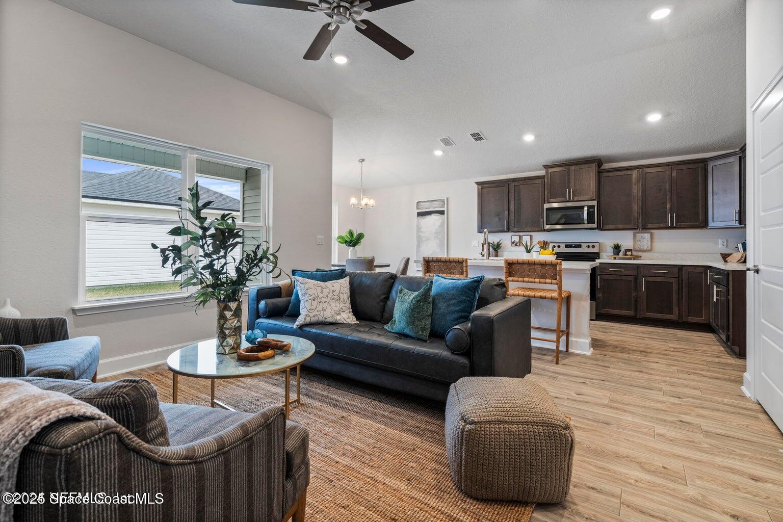 1211 Tupelo Circle Cocoa, FL 32926 - Photo 3 of 15 a living room with furniture kitchen view and a wooden floor