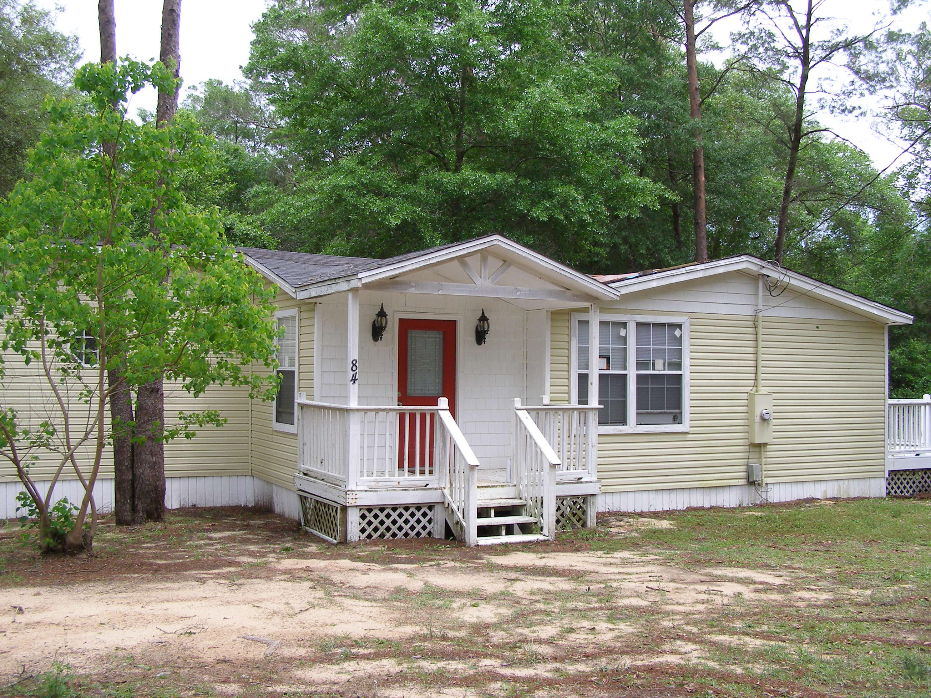 84 Roberts Road East DeFuniak Springs, FL 32433 - Photo 1 of 18 a view of a house with a yard and sitting area