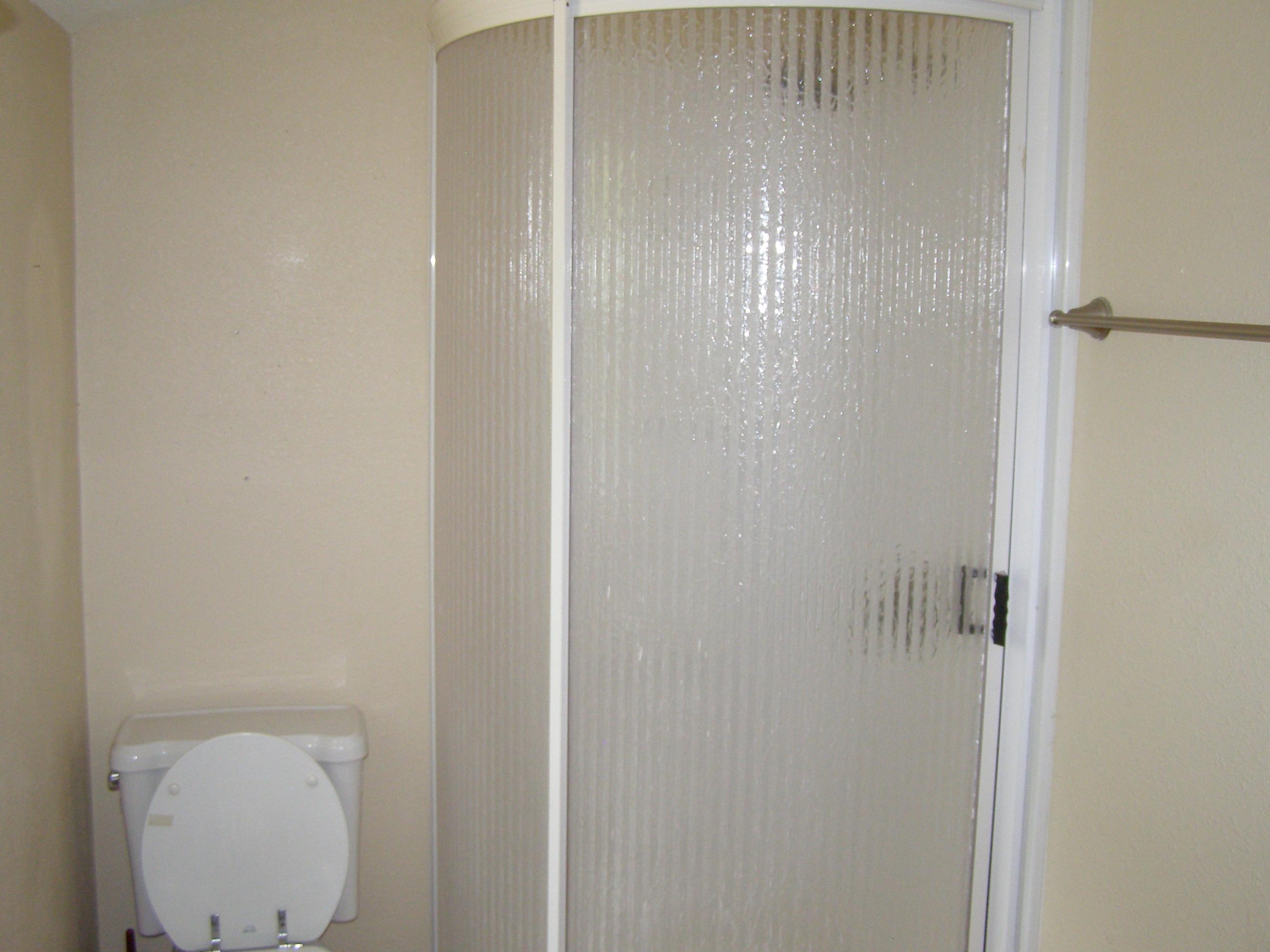 84 Roberts Road East DeFuniak Springs, FL 32433 - Photo 16 of 18 a bathroom with a glass shower door