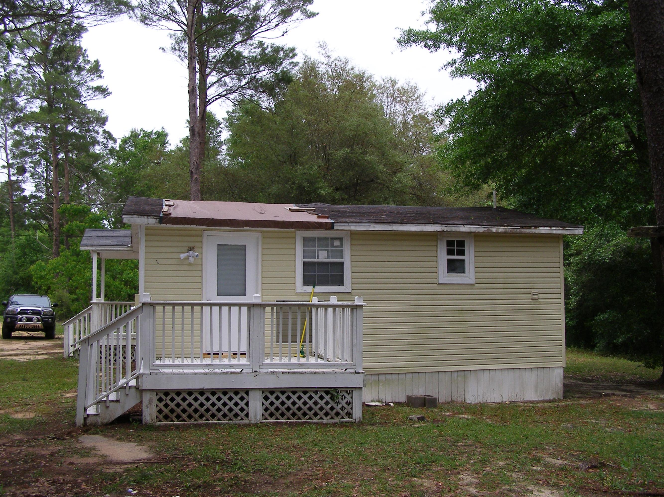 84 Roberts Road East DeFuniak Springs, FL 32433 - Photo 3 of 18 a view of a small house with wooden fence