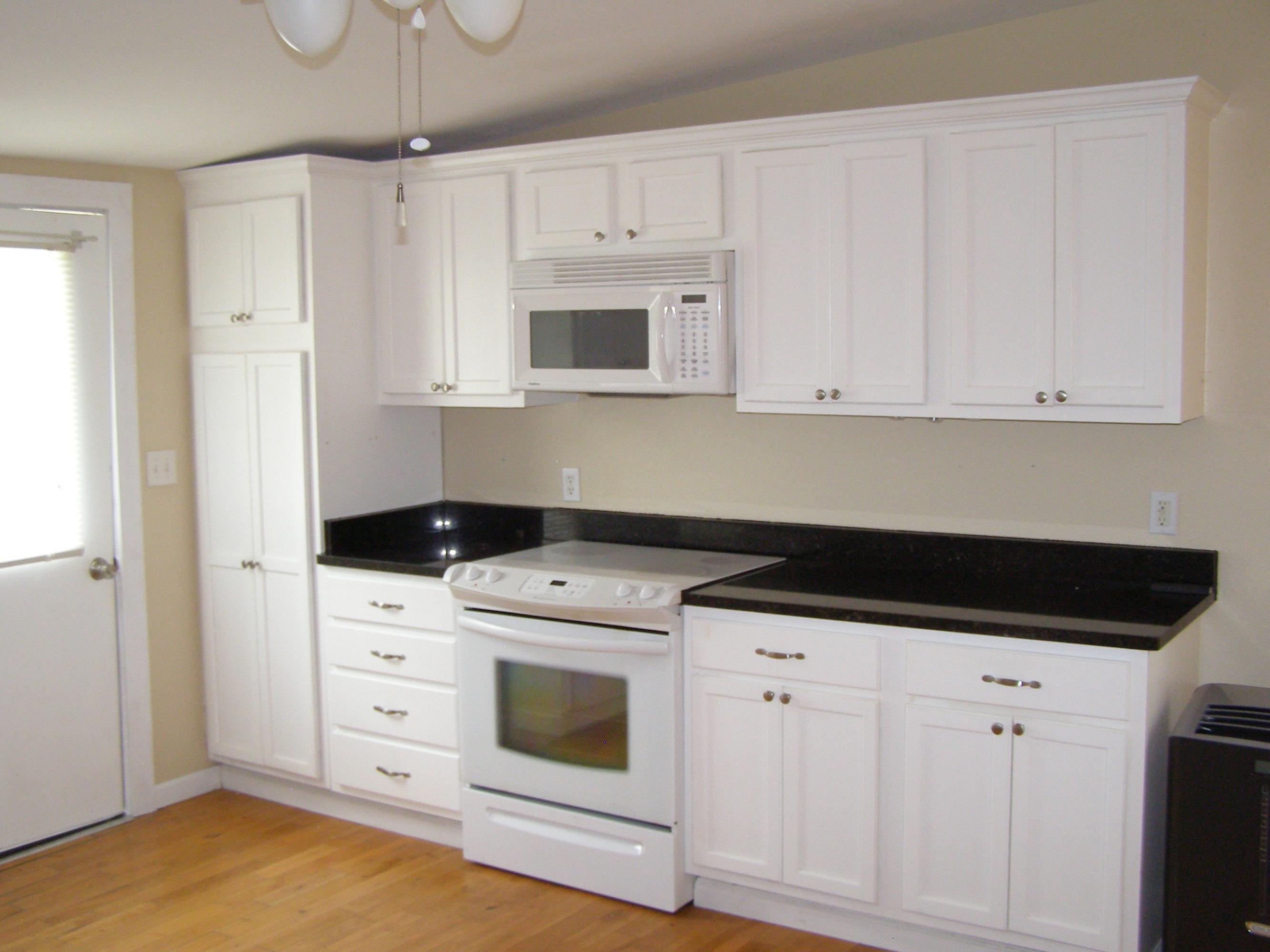 84 Roberts Road East DeFuniak Springs, FL 32433 - Photo 7 of 18 a kitchen with white cabinets and white appliances