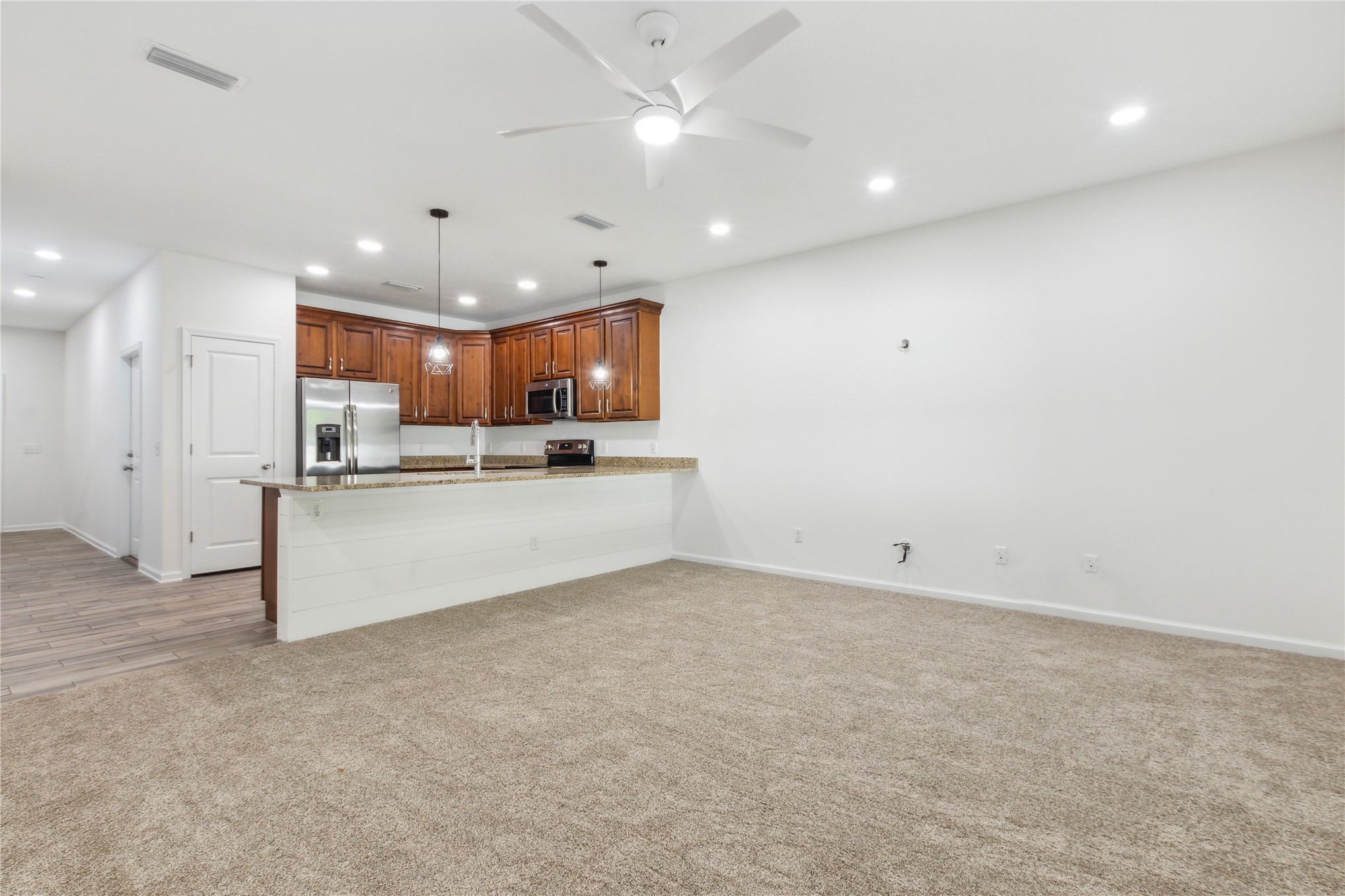 87279 Lents Road Yulee, FL 32097 - Photo 18 of 40 a view of kitchen with center island stainless steel appliances refrigerator sink and cabinets