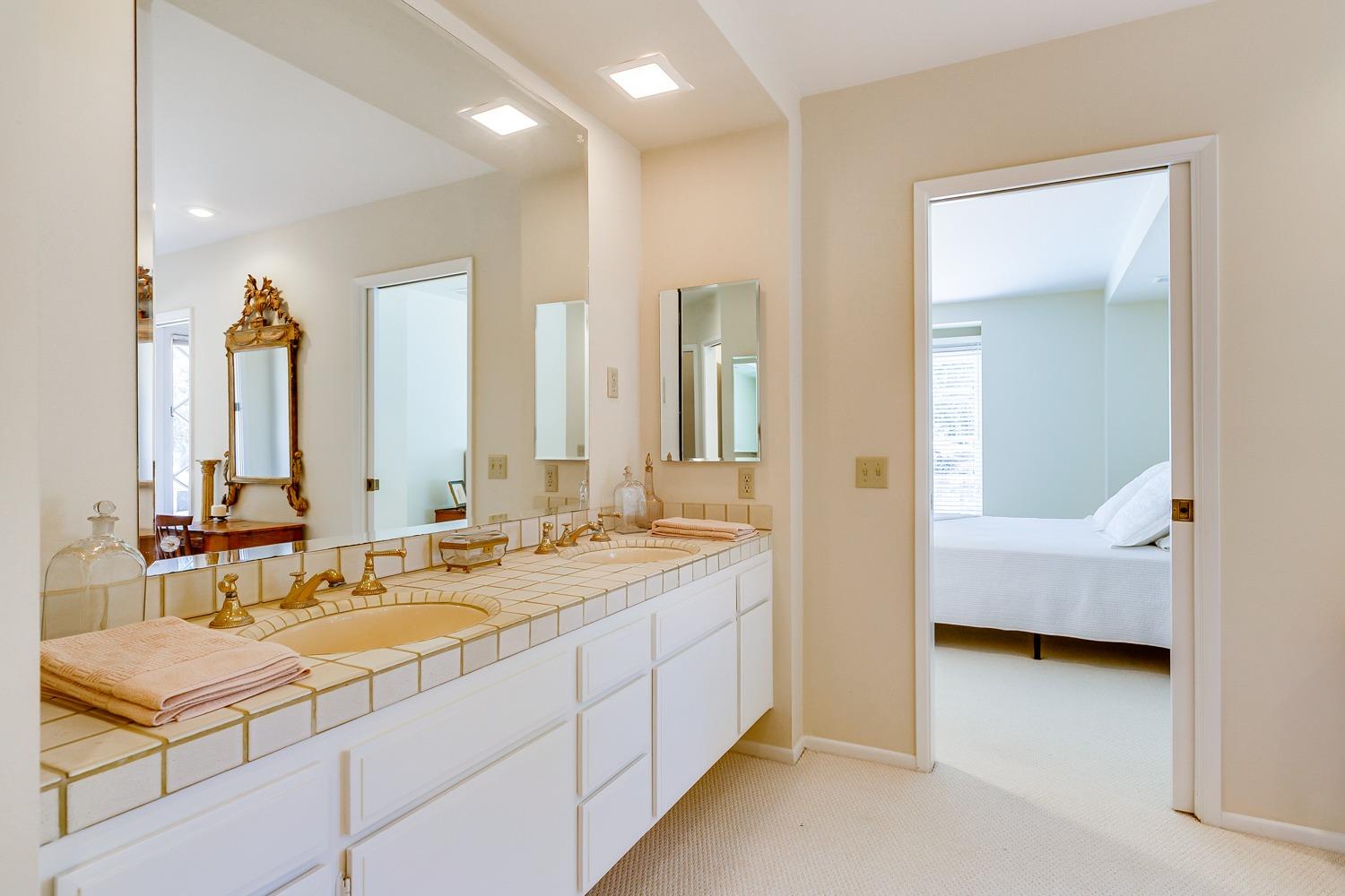 616 Palomar Road Ojai, CA 93023 - Photo 26 of 48 a en suite bathroom with a double vanity sink a mirror and a bathtub
