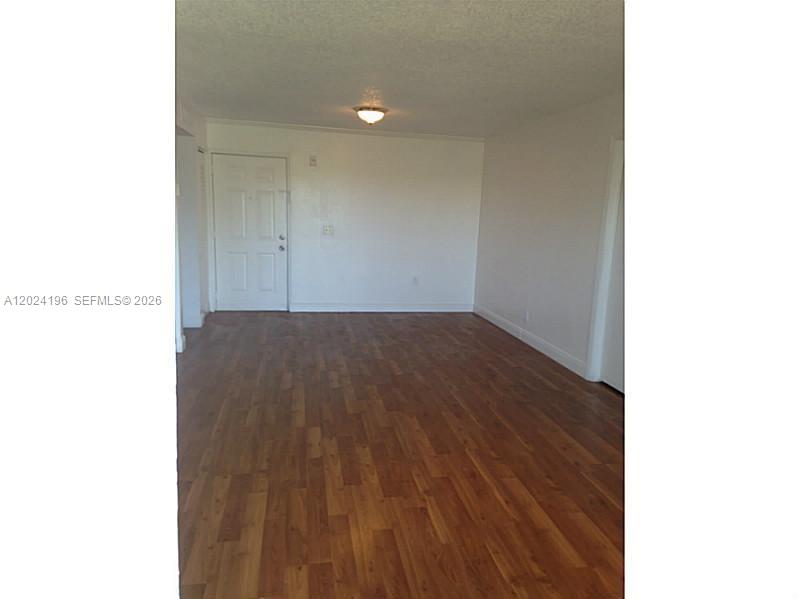 8260 Southwest 210th Street, Unit 319 Cutler Bay, FL 33189 - Photo 2 of 20 a view of a room with wooden floor