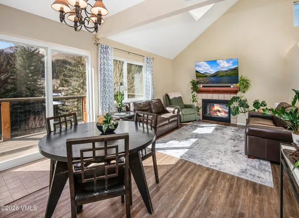 a living room with furniture a fireplace and a chandelier
