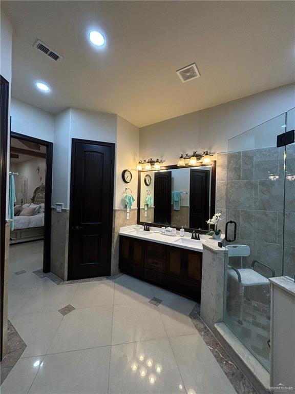 336 Navarro Street Pharr, TX 78577 - Photo 26 of 32 Ensuite bathroom with double vanity, a stall shower, recessed lighting, and tile patterned flooring