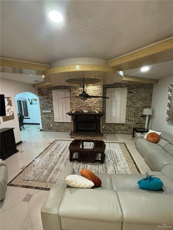 336 Navarro Street Pharr, TX 78577 - Photo 8 of 32 Living area featuring a stone fireplace and arched walkways