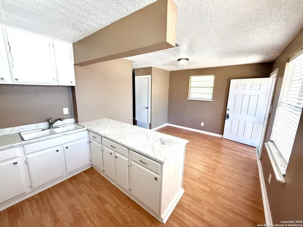 a spacious bathroom with a granite countertop sink toilet and a mirror