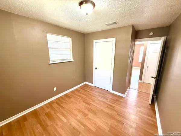a view of a room with wooden floor and windows