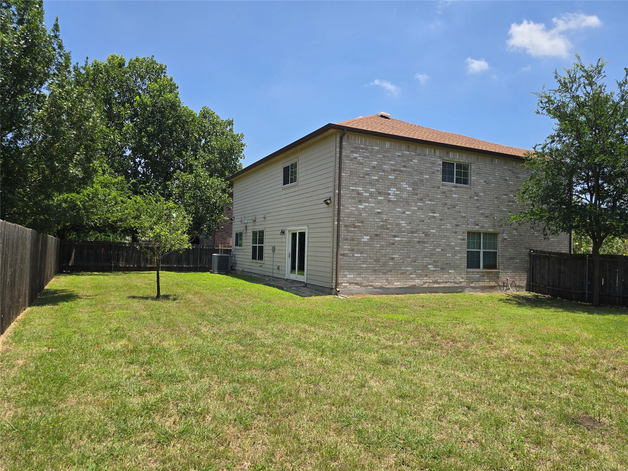 2021 Rim Rock Drive Leander, TX 78641 - Photo 13 of 14 A spacious yard perfect for outdoor enjoyment, offering a private setting with mature trees.