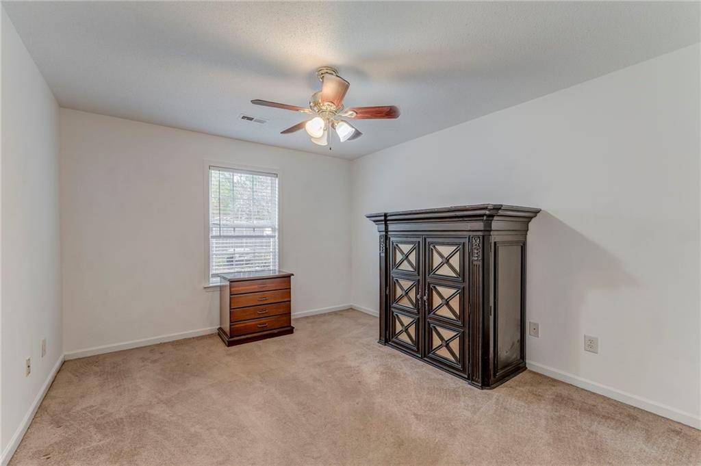 1A Green Acre Road Northeast Rome, GA 30165 - Photo 12 of 29 an empty room with windows and ceiling fan