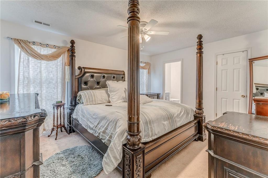 1A Green Acre Road Northeast Rome, GA 30165 - Photo 21 of 29 a bed room with a bed and a chandelier
