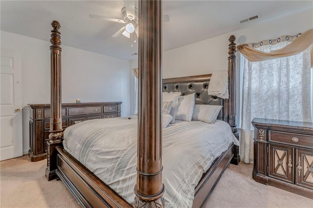 1A Green Acre Road Northeast Rome, GA 30165 - Photo 22 of 29 a bedroom with a bed and a chandelier