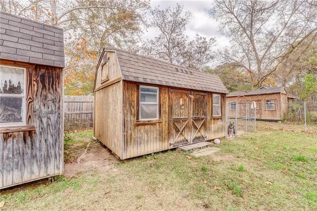a view of a house with a yard and wooden fence