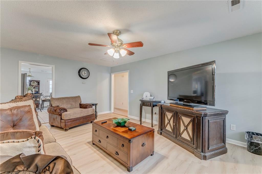 1A Green Acre Road Northeast Rome, GA 30165 - Photo 6 of 29 a living room with furniture and a flat screen tv
