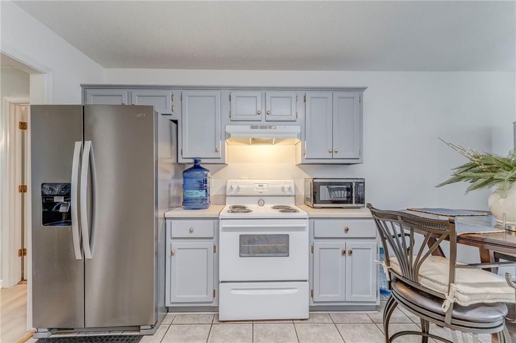 1A Green Acre Road Northeast Rome, GA 30165 - Photo 8 of 29 a kitchen with a stove refrigerator and cabinets