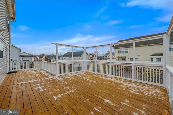 a view of a balcony with wooden floor and fence