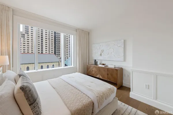 a spacious bedroom with a bed and a couch