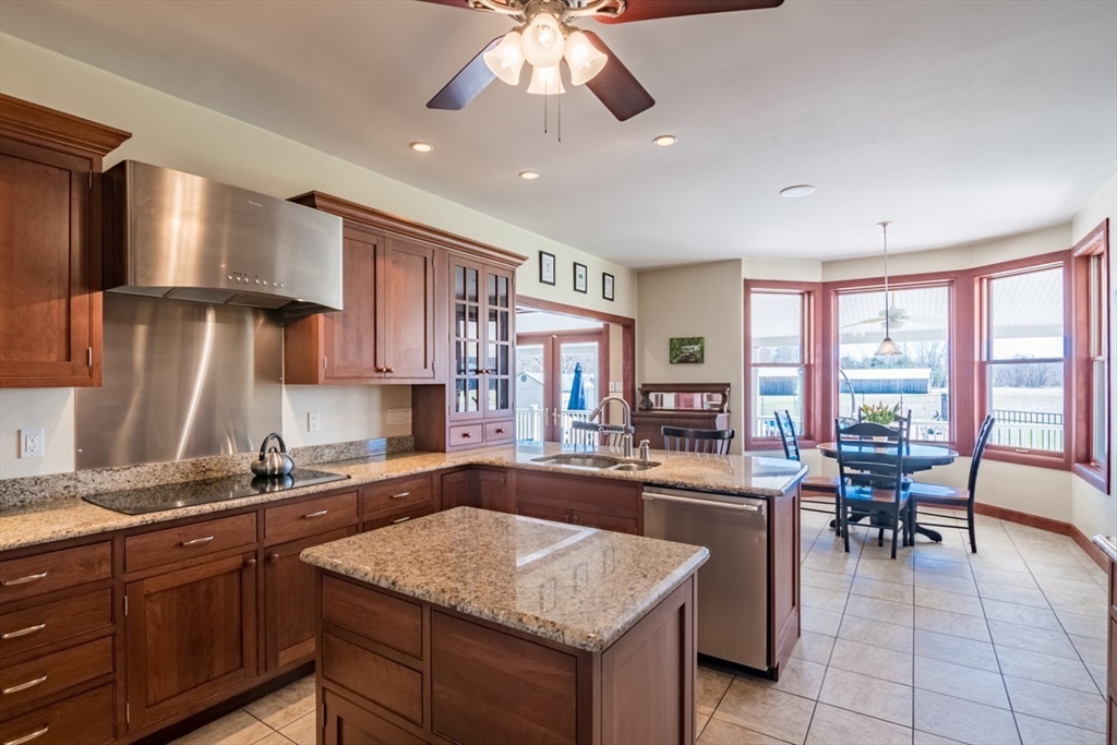 65 Bridge Street Hatfield, MA 01038 - Photo 16 of 40 a kitchen with a stove a sink a counter and chairs