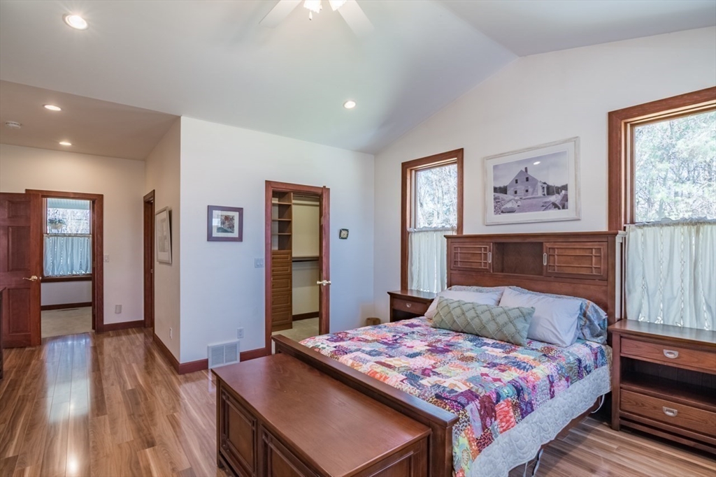 65 Bridge Street Hatfield, MA 01038 - Photo 17 of 40 a bedroom with a large bed and a chandelier