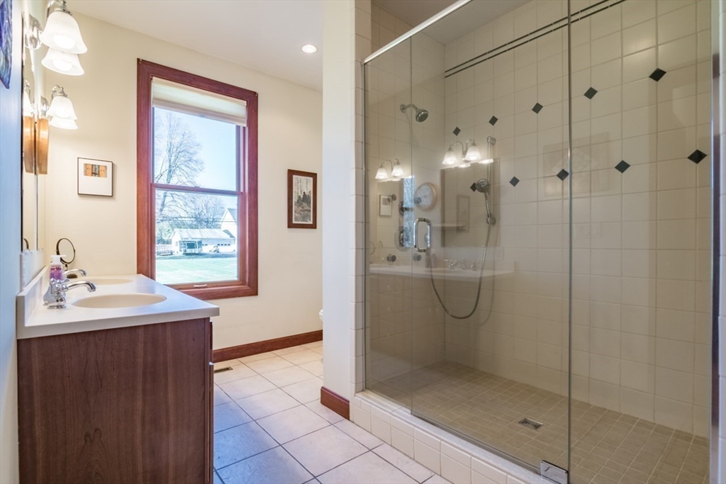 65 Bridge Street Hatfield, MA 01038 - Photo 20 of 40 a bathroom with a shower sink and mirror
