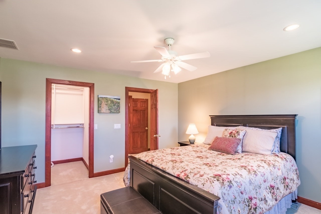 65 Bridge Street Hatfield, MA 01038 - Photo 23 of 40 a bedroom with a large bed and a chandelier