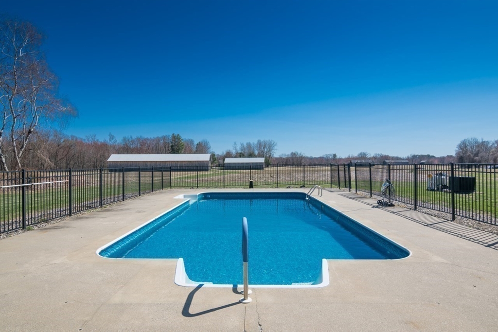 65 Bridge Street Hatfield, MA 01038 - Photo 35 of 40 a view of a swimming pool with a lounge chair