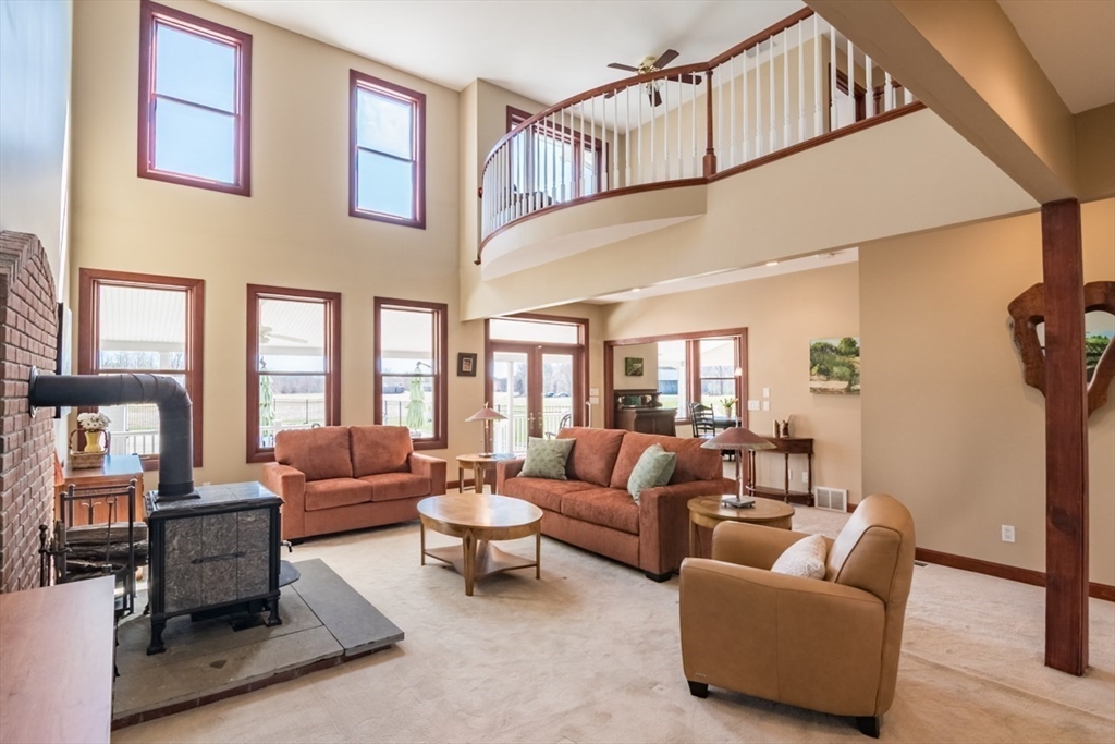 65 Bridge Street Hatfield, MA 01038 - Photo 4 of 40 a living room with furniture fireplace and a large window