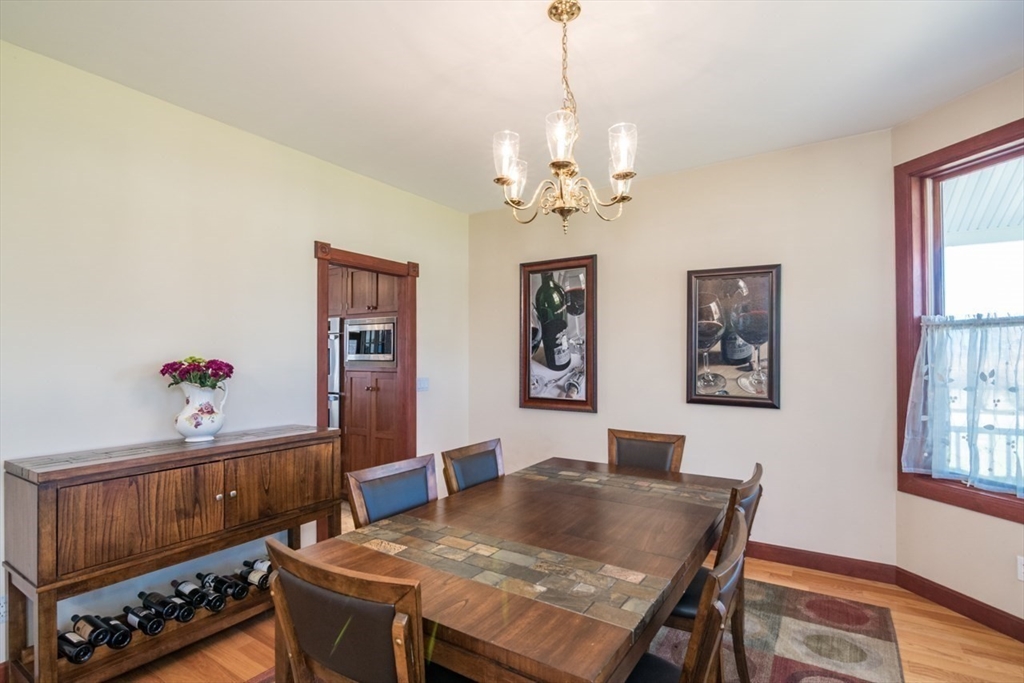 65 Bridge Street Hatfield, MA 01038 - Photo 9 of 40 a view of a dining room with furniture and chandelier