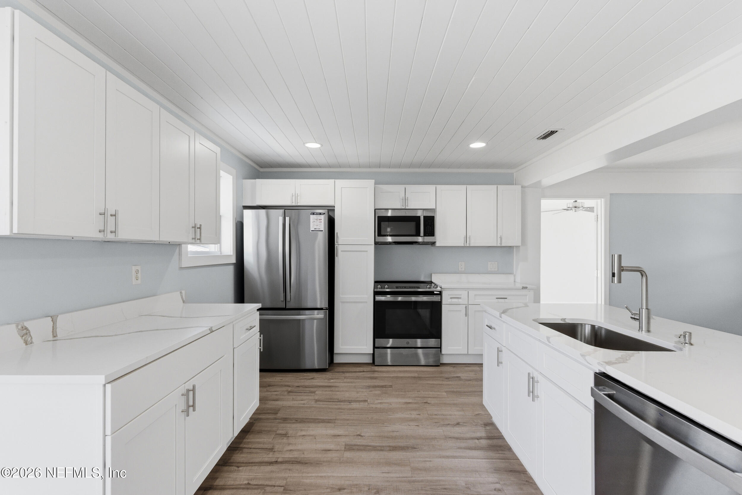 97150 Caravel Trail Yulee, FL 32097 - Photo 11 of 35 a kitchen with stainless steel appliances a refrigerator sink and cabinets