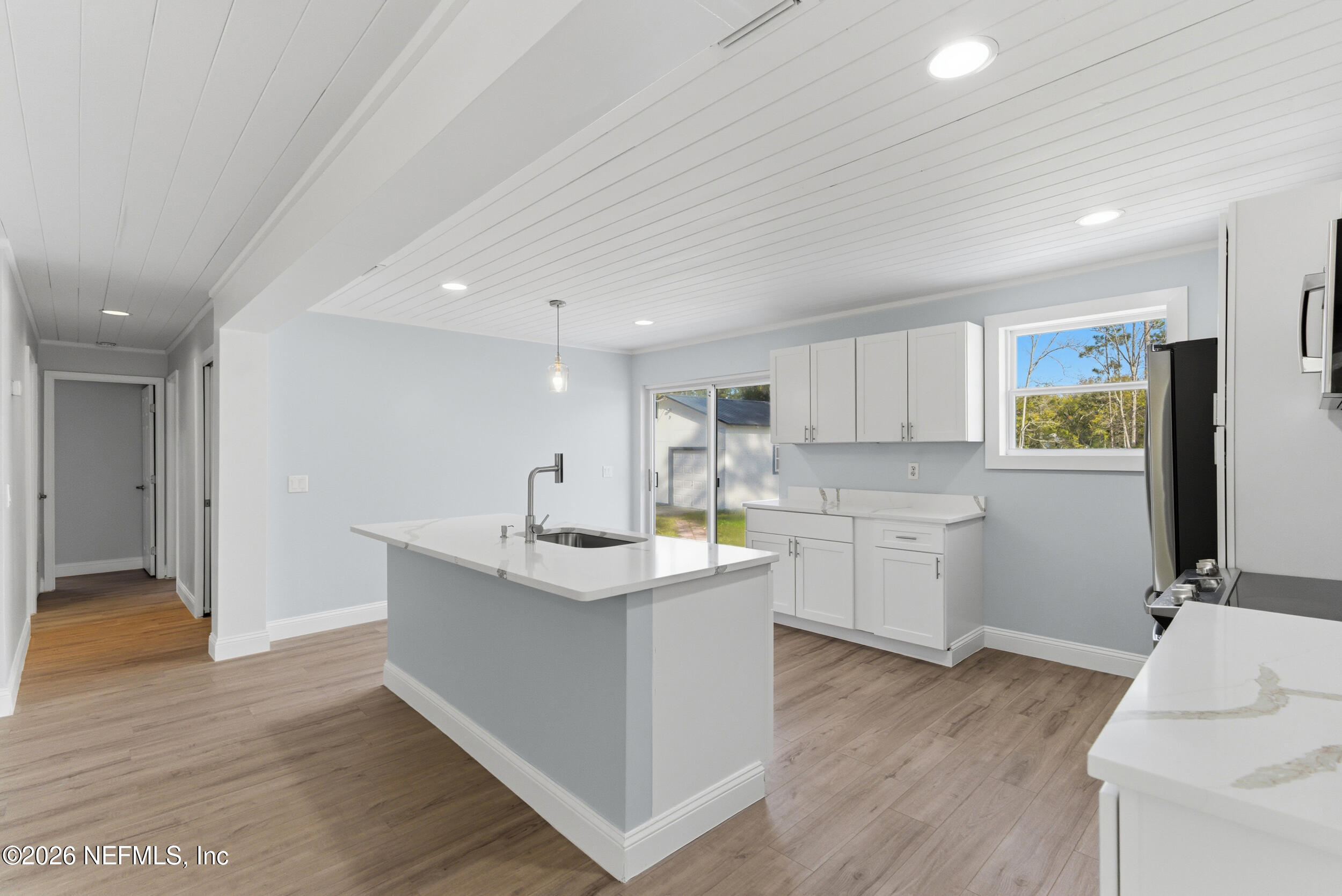 97150 Caravel Trail Yulee, FL 32097 - Photo 13 of 35 a kitchen with a sink cabinets and wooden floor