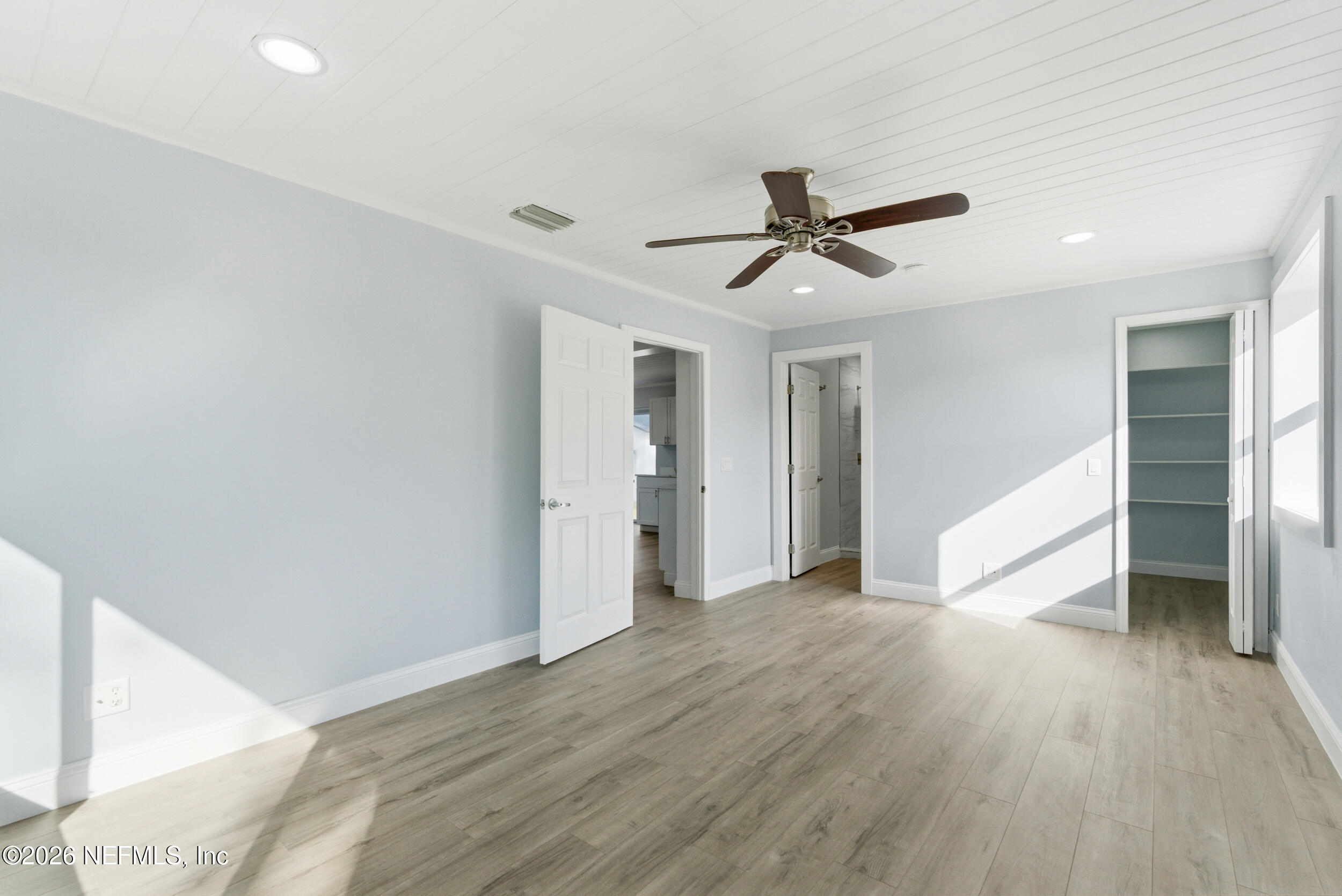 97150 Caravel Trail Yulee, FL 32097 - Photo 17 of 35 a view of a big room with wooden floor and a ceiling fan