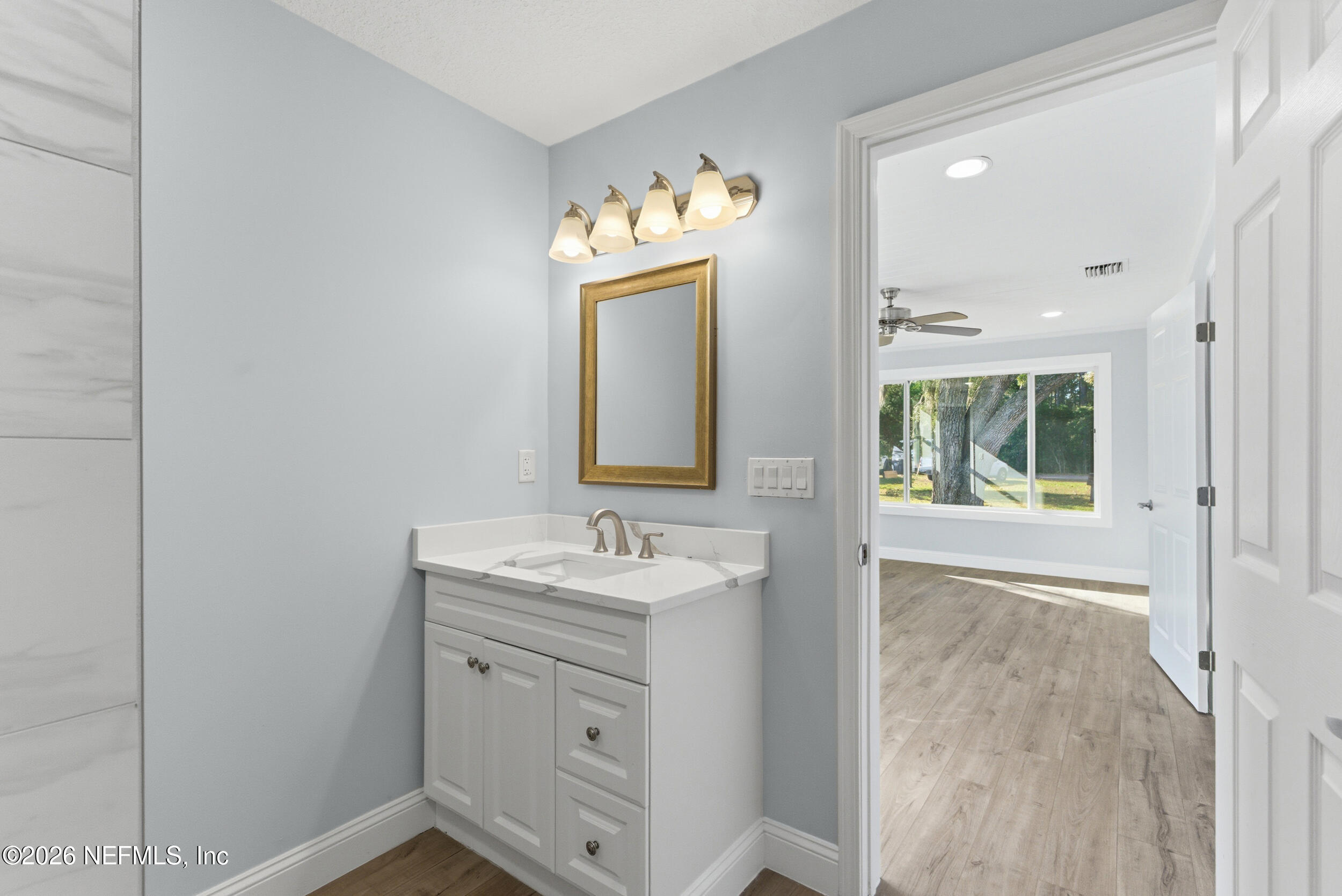 97150 Caravel Trail Yulee, FL 32097 - Photo 21 of 35 a bathroom with a sink and a mirror