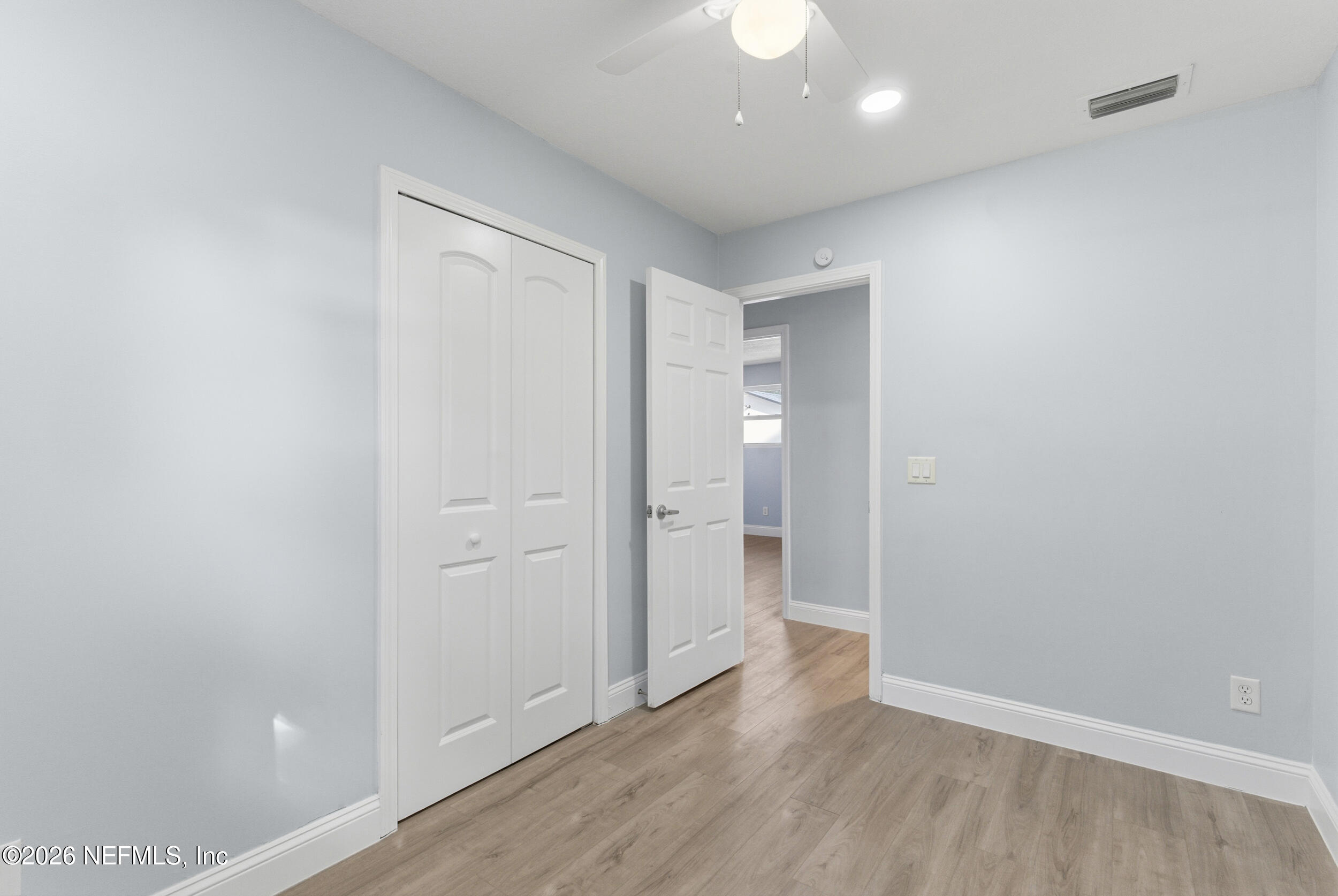 97150 Caravel Trail Yulee, FL 32097 - Photo 25 of 35 an empty room with wooden floor and windows